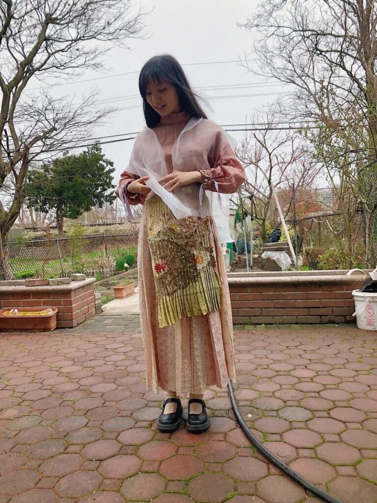 Chinese student of Parson's models a dress she made with fabric dyed naturally with onion skins.