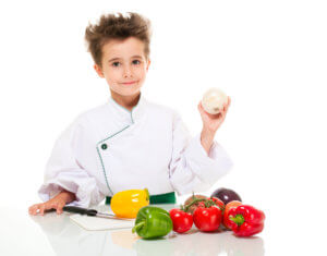 young chef holding onion