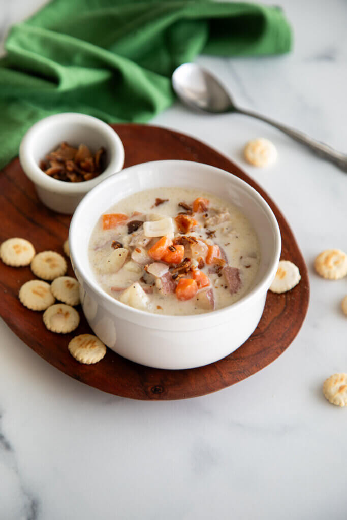 Bowl of New England Clam Chowder on Bord with cracers