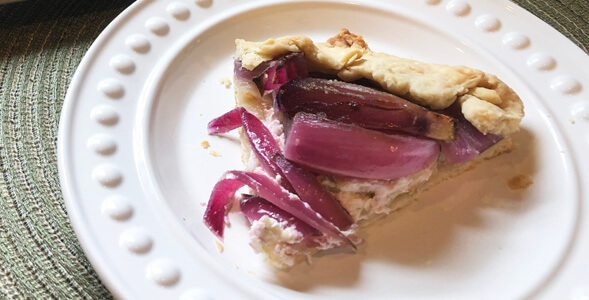 Slice of Onion Galette on white plate