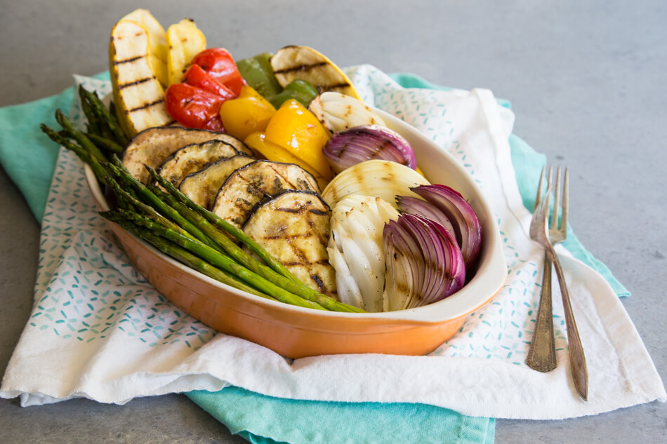 Grilled vegetables stacked in a casserole dish