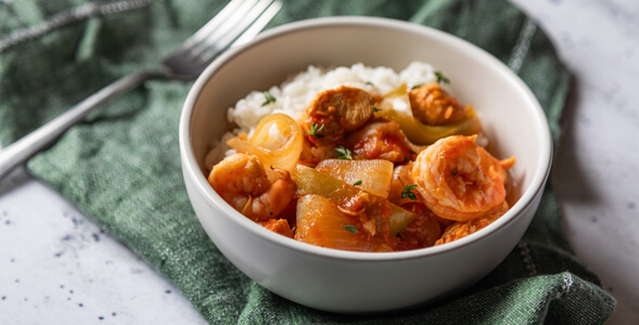 Zydeco Gumbo in white bowl on green napkin