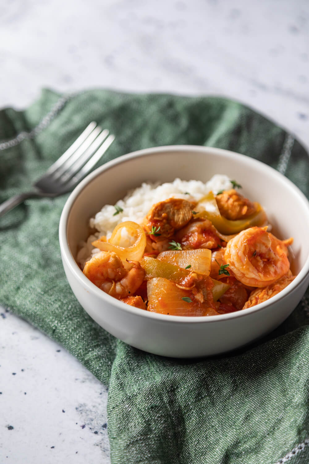 Zydeco Gumbo in white bowl on green napkin